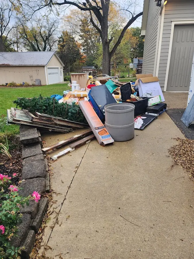 Dumpster being loaded with debris for Commercial Dumpster Rental in Alden